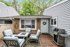 This charming two-bedroom, one-bath Condo exemplifies easy living with its inviting Ranch-style design, in the desirable section of Woodgate Village. As you enter, you will find a private, fully fenced in welcoming front deck that is ideal for relaxing or entertaining. This perfect end unit has two generous sized bedrooms with windows that let in an abundance of natural light. The living room opens to the dining area just off the bright white kitchen. There is a convenient laundry room equipped with a washer and dryer just off the kitchen with additional pantry storage. An additional key locked storage area can be found just outside the unit. On-site amenities are abundant, including a playground, tennis court, basketball court, pool and clubhouse with a recreational room and a full kitchen. Whether you are a first-time buyer, downsizing, or seeking a low-maintenance lifestyle, this Condo checks all of the boxes! Experience comfort and convenience at its best. Located close to restaurants, shopping and golf. Just minutes away from the Holbrook Country Club and transportation hubs, such as the LIRR Ronkonkoma Line and MacArthur Airport. This truly is a Home-Sweet-Home... (Directions for open house: Take SpringMeadow Dr and turn on to Ginger Lane and take to the end, follow the walkway on the right side to Unit I. Access to the Unit is on Ginger Lane there will be blue balloons)