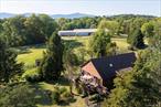 Welcome to the Horse Farm at Clermont! This very special property is set on 31 scenic acres in Germantown, NY, and combines equestrian facilities, farmstead living, and a spacious 3, 276 sq. ft. ranch home with sweeping mountain views. Designed with horses in mind, the farm features a 10-stall barn with wash stall (hot/cold water), heated and cooled tack room, 180&rsquo; x 80&rsquo; indoor arena, outdoor arena, and 10 paddocks - each with electric and heated auto water. Trails for riding or walking wind through the grounds, and a spring-fed pond adds to the idyllic setting. The ranch-style home, built in 1986, sits high above the farm overlooking the paddocks and barn. Inside, natural light fills the spaces, from the large eat-in kitchen with granite center island and deck access, to the inviting living room with fireplace. The main level offers a primary bedroom with an oversized walk-in closet, guest bedroom, office, full bath, and abundant storage. The finished lower level is ideal for guests or extended living, complete with its own foyer, spacious living/dining room with second fireplace, bedroom, full bath, laundry, and kitchen area - all with views of the paddocks. Outdoor living is equally impressive, with a deck for entertaining, a stone fire pit for cool evenings, and open land framed by the beauty of surrounding farmland and vineyards. Perfect as a horse farm, hobby farm, or country retreat, this property offers both privacy and convenience - just 2.5 hours from NYC and close to all the Hudson Valley&rsquo;s Columbia County has to offer, including the Clermont State Historic Site, wineries, and riverfront charm.