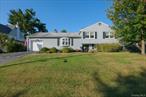 Set on the crest of Elm Street in the Mortgage Hill area of Peekskill, this well maintained custom built split level home offers warmth, space and modern comforts. This home has an open and airy feeling and an abundance of natural light. The large living room features a cozy gas fireplace. and large bay window The spacious country kitchen includes a generous dining area perfect for gatherings. A bright three season sun room with electric fireplace opens to a stone patio with awning and fenced in yard; ideal for entertaining. One step down from this room is the door to the garage. Upstairs; Large primary bedroom suite with private bath and two double closets,  Large second bedroom with double closet, third bedroom and a full bath in hall. Lower level has so much storage, furnace, laundry, office-den or family room and door out. There is a crawl space for additional storage over the garage. A split level style home does not have an attic. There is more than ample storage in lower level. Within convenient distance to shopping, schools and main arteries of transportation. Metro north is 1.3 miles away. Hardwood floors throughout this home. Seasonal riv3r view from the upstairs bedroom. Furnace and central ac, approx. 12 years. Seller does not know the age of the roof. In the last 5 years; new windows in front bedroom, sunroom and dining room. , kitchen overhead lighting, electric upgraded in home, huge awning and landscaping.  Approximately $63 quarterly for water. Electric, heating and cooling, approximately $400 per month