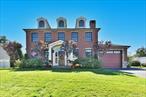 Presenting 1974 Monroe Avenue, an architectural masterpiece designed with the utmost attention to detail. This magnificent center-hall brick colonial has over 3, 800 interior square feet, featuring 4 bedrooms and 3 full baths, perfect for entertaining or everyday living. The home was built in 2016 and BETTER than new construction. The expansive layout is adorned with custom moldings, intricate wood detailing, grand arched doorways, soaring 10-foot high ceilings and elegant ceiling fixtures. Stepping into the grand entryway, the striking spiral staircase certainly sets the tone for the exceptional craftsmanship found throughout the home. The first floor features an entry foyer, spacious living room with wood-burning fireplace, formal dining room and open concept eat-in kitchen and family room, adorned with oversized Andersen windows, and where you will spend all of your time. The exquisite kitchen, constructed by renowned designer Ken Kelly, features an oversized 54â€X 121â€ foot island, imported Carrera marble throughout, double sinks, and Thermador stainless steel appliances, including dual full-size dishwashers, an oversized double refrigerator and a 6-burner gas range. A bedroom, perfect for an office or guest quarters, and a full bath complete this floor. Walking up the grand staircase takes you to a large primary suite. Walking through the beautiful French doors you are greeted with a large bedroom, a double-sided gas fireplace and a private balcony overlooking the beautifully landscaped backyard featuring specimen perennial plantings. The lavish en-suite marble bathroom features an oval-jetted jacuzzi tub, gas fireplace, a spacious shower with custom jets, high ceilings and double vanity area. 2 additional bedrooms, a full bath and laundry room, offering Electrolux washer and dryer, complete this floor. Some highlights of the home include central air conditioning, gas heating, hardwood floors, 5-zone in-ground sprinkler system, gleaming hardwood floors, an oversized basement with private entrance and a 1.5-car attached garage. Step outside into your personal oasis... the backyard beckons with an 18â€™X36â€™ in-ground pool, a relaxing hot tub and outdoor pool house with shower. The backyard is complemented with an expansive patio area complete with a covered dining area with tv, perfect for al fresco dinners or just watching a football game with friends. The house is located in close proximity to restaurants, shopping, schools and highways. Featuring traditional architecture and the finest details throughout, this classic home will capture your heart at the front door and is not to be missed.