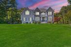 This colonial offers more than 4, 000 sq. ft. of space, including 2, 819 sq. ft. above grade and 1, 363 sq. ft. of high-ceiling basement space ready to be finished. Set on 2.27 acres in the Shagbark subdivision, the property combines privacy with convenience to the Taconic Parkway, shopping, and restaurants. Inside, youâ€™ll find a dramatic two-story foyer with tall windows and a spacious kitchen with cherry cabinetry, granite counters, stainless steel appliances, wine fridge, and a built-in desk area. The breakfast room opens to a deck overlooking the level backyardâ€”ideal for play, entertaining, or a future pool. The primary suite includes a sitting area, private deck, and a bath with dual vanities and whirlpool tub. Upstairs also features three additional bedrooms, a full bath, and laundry. Other details include hardwood and tile floors throughout, multiple French and sliding doors that bring in natural light, spacious walk-in closets, exterior lighting, landscaped grounds, and a level backyard with room for outdoor activities or a pool. The high-ceiling basement provides endless possibilities for additional living space.