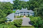 An Estate of Distinction in the Heart of Sands Point. Set gracefully on over two acres of meticulously manicured grounds, this bespoke Kean-built colonial is a masterclass in architectural elegance and refined living. Located in the coveted Harriman Estates section of Sands Point, this extraordinary residence is approached by a sweeping, tree-lined drive that offers a grand first impression and a lasting sense of arrival. Designed by renowned architect Andrew Giambertone, the home seamlessly blends classic sophistication with modern luxury. Inside, six generously proportioned bedrooms and four and a half designer bathrooms are complemented by soaring ceilings, abundant natural light, and tranquil views of the estateâ€™s lush gardens. Each space has been thoughtfully curated to evoke a sense of serenity and grandeur. At the heart of the home, a reimagined chefâ€™s kitchen showcases top-of-the-line appliances, custom cabinetry, and a sun-drenched breakfast area. The adjacent great room, with its dramatic cathedral ceiling and sleek gas fireplace, serves as an elegant setting for intimate gatherings or larger scale soirees. The outdoor amenities rival those of a private resort. An expansive patio surrounds a beautiful gunite swimming pool, while the fully equipped outdoor kitchenâ€”with two built-in grilling stationsâ€”invites seamless indoor-outdoor living and al fresco dining. Crafted with exceptional materials and fine artisanal detail, this residence offers a unique opportunity to acquire a truly exceptional home. Additional features include a full-house generator, three-car garage and courtyard driveway. Residents of Harriman Estates enjoy deeded access to private beach and paid access to The Village Club of Sands Point. Additional golf courses, yacht clubs, and country clubs are just moments away. An exceptional offering in one of Long Islandâ€™s most prestigious enclaves.