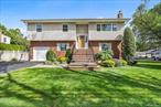 A rare opportunity to own a High Ranch with a full basement featuring an outside entrance, 128 N Windhorst Ave offers space, flexibility, and a sought-after location in Bethpage. The classic exterior with its welcoming front presence and well-kept property sets the tone for this versatile home. Inside, youâ€™ll find 5 bedrooms and 4 full bathrooms, including a private en-suite primary. Hardwood floors grace the second-floor bedrooms and main living areas, while the first floor and basement feature primarily engineered flooring for durability and style. The open living room flows seamlessly into the dining area and kitchen. With a full basement and separate entrance, this home presents an ideal setup for a potential mother/daughter arrangement with proper permits. Laundry is conveniently located in the basement. The property includes a fully fenced backyard with a patioâ€”perfect for outdoor gatherings and relaxation. Enjoy being moments from Bethpage town center, schools, shopping, dining, and public transportation. Offering both comfort and convenience, this spacious home is ready for its next chapter.