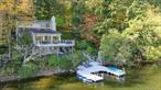 Magical lakefront retreat! Spectacular well maintained contemporary home located on Lake Oscaleta with 146 feet of direct lake access. Bright three level VIEW home. Soaring ceilings, skylights, floor to ceiling windows, wood-burning fireplace, and private setting. Wrap around view deck. Flexible floor plan. Main floor with kitchen, spacious living room/dining area, den, bedroom, and full bath. Upper level has spacious master suite, with dressing area, bath and expansive lake views. Lower level has full bath and space perfect for guests or private office with separate entrance. Connected by direct access to Lake Waccabuc and Lake Rippowam. Fresh water lake! U shaped dock perfect for water lovers! Swim, boat, fish, and ice skate - year-round outdoor enjoyment. This amazingly special view home will not last! Sale includes two lots. Lives as a three bedroom.