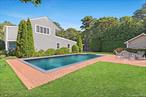Tucked away on a private flag lot south of the highway, this five-bedroom, three-bathroom residence captures the essence of a Hamptons summer retreat. The main level unfolds with a bright, airy living room and a galley kitchen with stainless steel appliances that connects to the dining area. A generously sized primary suite with walk-in closet and an additional spacious bedroom with a full hallway bath complete this floor. Upstairs, an open lounge space anchors three more bedrooms and another full bath-perfect for guests and gatherings. Outdoors, mature landscaping frames the yard, where a sun-soaked deck and brick patio invite al-fresco dining. An 18x36 heated pool serves as the centerpiece, offering the ultimate spot to swim, unwind, or simply enjoy a quiet afternoon. Ideally located just minutes from Ponquogue Beach, Shinnecock Bay, and Meschutt Beach, with easy access to waterfront dining, this home combines comfort and convenience in equal measure. A true summer haven ready to be enjoyed. Jun $25k, Jul $30k, Aug-LD $35k.