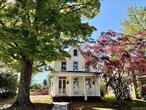Charming 1875 Victorian - Wallkill Character Awaits!?Step back in time and fall in love with this meticulously maintained 1875 Victorian home, nestled in the heart of the charming Hamlet of Wallkill. This isn&rsquo;t just a house; it&rsquo;s a piece of history, brimming with original character and ready for its next chapter. ?A grand double-door entrance welcomes you into a home where history meets warmth. The stunning living room is a true showpiece, featuring a majestic tin ceiling and a beautiful fireplace mantle, just waiting to be adorned with festive decorations for the upcoming holidays. Throughout the house, you&rsquo;ll find rich pine floors and exquisite wood trim and staircase, showcasing the craftsmanship of a bygone era. The main level boasts a spacious eat-in kitchen and a separate dining room, perfect for gathering friends and family. For your storage needs, there&rsquo;s a full walk-up attic, offering ample space to keep your home clutter-free.Relax and watch the world go by on your classic rocking chair front porch, updated with durable Trex decking. The property also features a large, over-sized barn, the perfect space for a hobbyist, a woodworker, or a car enthusiast needing extra storage or a workshop. The generous yard provides plenty of space for entertaining guests or simply enjoying the outdoors. You simply cannot beat this prime location! Enjoy the ultimate walk-able lifestyle, situated just one block from the Rail Trail and a short stroll to local stores, restaurants, the library, police station, and schools. ?For the nature lover and adventurer, you&rsquo;re only minutes away from the breathtaking beauty of Minnewaska State Park, the scenic trails of Mohonk Mountain, local wineries, and seasonal apple orchards. Commuting is a breeze with Stewart International Airport and the Metro-North train station also just a short drive away. Don&rsquo;t miss the chance to own a piece of Wallkill&rsquo;s rich past with all the convenience of modern village living!
