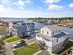 Welcome to this waterfront Colonial in the Meadowmere Park area of Lawrence. This home offers spacious living and excellent potential for customization. The first floor includes a large garage and storage area. The second floor features a bright living room, dining room, eat-in kitchen with center island, laundry room, boiler room, two bedrooms, and a full bath. The third floor offers three additional bedrooms, a bathroom, and beautiful water views. Outdoor possibilities include building your own private boat dock and a deck over the water. Convenient location close to major supermarkets, shops, and transportation. Long driveway with large garageâ€”must see!