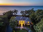 This Sound Front home at the edge of a quiet Orient cul-de-sac is more than a haven-it&rsquo;s a destination for those who appreciate the rare union of luxury, privacy, and personality. Here, drama is found in the sweep of panoramic water views and the hush of mornings on a private deck, just upstairs from your own sandy shoreline. Step into soaring, sunlit spaces designed for living boldly: a cathedral-ceilinged great room crowned by a Niamh Barry light sculpture, six uniquely serene bedrooms, and a media lounge fit for both celebration and retreat. Two grand spiral staircases anchor the heart of the home, while an elevator ensures every level is effortless. This is a house that thinks ahead-10-foot ceilings, custom red oak flooring, radiant heat where you want it, a climate-controlled wine room, a butler&rsquo;s pantry for flawless entertaining, and double laundry rooms for seamless living. Outside, a 34&rsquo;x13&rsquo; Gunite heated infinity pool and 8&rsquo;x8&rsquo; spa blend into Sound views, with private stairs leading to the beach for spontaneous escapes. Security, comfort, and modern ease are ever-present with remote cameras, central vacuum, a triple-car garage, a full-house generator, and avant-garde HVAC and audio systems-leaving you free to focus on what really matters: sunrises, open water, and time well spent. For those who believe a home should never feel ordinary-this Orient retreat awaits.
