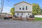 9 Bedroom 2 full bath home, Part basement, 2 detached car garage, and plenty of parking spaces. Multifamily Residence as per town records. Needs some TLC. 5 minutes from Huntington Station Train Station. Gas heat.