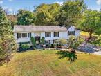 Discover the perfect blend of comfort and tranquility in this well-maintained expanded home, featuring almost 2, 400 square feet set on nearly 3 lush acres. Tucked away from the road, this home offers a serene country setting, backing up to forever-green property, all while being part of the Millbrook School district. The standout feature is the massive addition of the primary bedroom suite, which offers versatility as a spacious family room. With up to 3/4 bedrooms and 3 full baths, this home is perfect for growing families or those welcoming extended family. The beautifully designed kitchen features solid hickory soft-closing cabinets, a slate backsplash, double sinks, a breakfast counter, red oak flooring, and ample storage for all your culinary needs. Light and Bright Open Floorplan with wood flooring, recessed lighting, 6-panel doors, an attic fan, and upgraded 200-amp electric.The lower level features a cozy recreation room with a pellet stove and stylish wainscoting, alongside a mud area, full bathroom, laundry area, and an additional room ready for your personal touch with plenty of possibilities, including the perfect in-law set-up.  Enjoy the outdoors on the expansive 20 x 20 deck, overlooking a private, peaceful backyard thatâ€™s perfect for relaxation or entertaining. This home also includes an oversized 2-car garage with a storage/workshop area. Enjoy all the recreation, restaurants, and shopping that the Hudson Valley has to offer, plus low taxes!