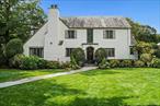 Modern vibe meets classic charm in this spectacular updated English Tudor, gracing over a third of an acre in one of New Rochelle&rsquo;s most sought-after locations. With magnificent curb appeal and stunning original architectural details perfectly paired with tasteful updates, it&rsquo;s easy to fall for this beauty. The gracious entry foyer opens to a breathtaking sunken living room with 12-foot ceilings, fireplace and remarkable original stained glass windows which have been artfully restored. The fabulous family room features skylights and wall to wall windows overlooking the gorgeous gardens, porch and patios. A formal dining room opens to the captivating grounds, seamlessly blending the indoor and outdoor entertaining space. Recently updated, the eat-in kitchen presents extensive cabinets, granite counters and new stainless steel appliances. The first floor is complete with a powder room as well as a coveted first floor bedroom with a beautiful ensuite bathroom. All bedrooms feature deep closets and all five bathrooms have been redone with designer touches. The spectacular primary bedroom features a sitting area, double closets and an ensuite bath with double sinks and a walk-in shower. There are striking original details at every turn, and this haven is as pristine as can be. Enjoy recessed lighting, handsome hardwood floors and three-zones of central air conditioning and heating. Home is wired for portable generator, a wireless ADT security system and boasts a two car garage with high ceilings, epoxy flooring and storage. Plus, the basement provides over 1000 sq ft of inviting bonus space. Nestled amongst mature trees and specimen plantings, the backyard is a private, tranquil oasis. All this, in a convenient location near shopping, restaurants, schools and worship. Just a 30 minute train ride to NYC.