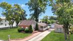 LOW Taxes! Connetquot Schools! Set on a .33-acre lot, this expanded Cape blends comfort, character, and unlimited potential. The home features a recently upgraded eat-in kitchen with quartz countertops, white cabinetry, stainless steel appliances, and a pantry closet. The primary suite includes two oversized walk-in closets, space for a king bed, and a private en-suite bath. The vaulted ceiling living room with a striking stone wood-burning fireplace is the centerpiece of the home, while hardwood floors, recessed lighting, and a bright sunroom add warmth and natural light throughout. Step outside to your very own backyard oasis designed for entertaining and everyday enjoyment. A wraparound deck leads to the above-ground pool, perfect for summer gatherings. A cozy fire pit, bocce court, and an extra shed for storage, while the 2-car garage provides additional room for cars, tools, or a workshop. With a flexible layout that even allows for the possibility of a third bedroom, this home can be customized with your needs. Location is unbeatable; 2 miles to the Ronkonkoma train station for an easy NYC commute, just 1 mile from MacArthur Airport, and close to Veterans Highway, Sunrise Highway, Connetquot State Park, schools, shopping, and dining. With LOW taxes, a prime location, and a perfect balance of upgrades and expansion potential, this move-in ready home truly is the Best Deal in Bohemia.