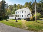 Tastefully updated for modern comforts, this 1868 historic farm house is an absolute charmer in a dreamy location, just a 10 minute scenic drive to the villages of Woodstock or Saugerties.Step through the foyer into the bright and airy eat-in kitchen. The view from the sink showcases an expansive pond with seasonal lily pads. Two connected year-round sunporches offer a flexibility to the open layout plan of the first floor and extra square footage. Use these serene spaces to relax, to work, or as guest space. A fine gas powered Jotul woodstove lends an easy comfort to the living room. Upstairs, youâ€™ll find four cozy bedrooms, each with a unique view of the property. The upstairs bathroom is home to what is likely the cutest clawfoot soaking tub you have ever seen. The property is situated at the end of a town maintained no-outlet road. The house is set against the backdrop of a stunning rock face where bluestone was once quarried. Apple trees, blueberry, raspberry, and blackberry bushes, an herb garden, and well maintained perennial beds adorn the lawn. A stacked stone fire pit and grill is a center for dining al fresco. A two car garage and a workshop/studio building provide ample project space. The 6+ acres include two possible sites to expand with total privacy from the existing residence; One atop a hill with road frontage on Glasco Turnpike, and one with access to the pond at the end of Nista Road.