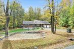 Welcome home to your weekend retreat nestled in stunning Columbia County! Discover this 3-bedroom (that lives like 4 bedrooms) ranch on almost 10 acres of absolute bliss. This oasis has an open floor plan of almost 2000 square feet with a 2 car attached garage offering both comfort and functionality in a peaceful, wooded setting. As you step onto the front porch that is perfect for entertaining, you will be greeted by the bright and inviting foyer. The spacious living room features large picture windows that fill the space with natural light, highlighting the gleaming wood floors and the stunning double-sided stone fireplace â€” a true centerpiece that adds warmth and character while separating the formal dining area. The walk-through kitchen offers ample cabinets, stainless steel appliances, and a convenient high-top seating area for casual dining. Wooden beams throughout the home enhance the cozy, cabin feel, creating a space thatâ€™s both stylish and inviting. All bedrooms and the full bath are conveniently located on the main floor. From both the dining and family rooms, sliding glass doors open to the expansive back deck â€” ideal for entertaining or simply relaxing featuring a unique gazebo covering a hot tub for all year round fun and relaxation. Unwind by the outdoor wood-burning stove on the lower patio and take in the beautiful views of the leveled backyard surrounded by nature. This home is perfect if you are looking for seclusion, charm, along with functionality, this property offers the best of country living â€” just minutes from the heart of Germantown and Hudsonâ€™s vibrant shops and restaurants. Donâ€™t miss the opportunity to see this charming country retreat! Can be packaged with 111 acre lot down the street on Rt 82, MLS # 917904.