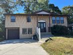 This home offers four bedrooms up with a living room, kitchen and bath. The downstairs features an eat in kitchen, bath, dining room, office and bedroom or denIt is a large home and can obtain an accessory permit for the downstairs. It has an attached garage and a fenced yard! And has a new roof, cesspool and driveway!.