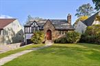 This stunning split-level Tudor in Huntâ€™s Wood, just steps from the Bronxville Field Club, is a charming and elegant place to call home!The first floor features a spacious living room with a gorgeous stone wood-burning fireplace, custom built-in bookshelves, and beautifully crafted architectural doorways. The generous dining room is perfect for hosting dinner parties and flows seamlessly into a sun-drenched sunroomâ€”currently used as a home officeâ€”with serene views of the lush backyard. The updated kitchen boasts wood cabinetry, granite counters, stainless steel appliances (gas range and dishwasher replaced in 2022), and a stylish glass tile backsplash. Only a few steps up from the main living area are two bedrooms, one perfect for the primary bed, with crown molding and the second with new carpeting. These share a full updated bathroomâ€”creating the feel of convenient one-floor living. The third floor offers two additional bedrooms and a second full bathroom, complete with upgraded fixtures and charming mid-century modern green tile. A few steps above that is a spacious attic storage area, newly insulated for added efficiency and year round use. A full basement houses the laundry, mechanicals, and additional unfinished storage space. Additional upgrades include: New roof (2023), Exterior Trim Painted, Air conditioning mini-split installation, Upgraded Trex deck. This home combines timeless Tudor style with thoughtful modern upgradesâ€”donâ€™t miss your chance to enjoy everything this beautiful home has to offer!