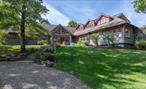 Nearly 30 secluded acres of rolling meadows and woodlands unfold into breathtaking panoramic views of the Catskill Mountains. This is a place to slow down and reconnect. Reminiscent of the Adirondack Great Lodges, this home is a masterful blend of rustic elegance and timeless craftsmanship. Soaring, strap-and-beam ceilings create a dramatic sense of space, while a custom-crafted staircase and a floor-to-ceiling wood-burning stone fireplace add to the home&rsquo;s warmth and grandeur. Step from the main living area out onto the brick patio to take in sweeping sunset views over the mountains. The expansive dining room easily accommodates large gatherings, and features a cozy window seat ideal for lounging while soaking in the views. The chefâ€™s kitchen is both stylish and functional, featuring a beamed tin ceiling, tile flooring, and stone countertops that lend a timeless elegance. Just off the kitchen, step into your private outdoor oasis. This expansive patio features a pergola draped in mature, blooming wisteria. At the heart of the space is a fully equipped built-in barbecue station perfect for hosting al fresco dinners or weekend cookouts. A half bath, laundry room, and walk-in pantry offer added convenience, leading directly to the attached garage. The first-floor primary ensuite has westerly mountain vistas, direct access to its own private deck, and a secluded outdoor shower. Three additional bedrooms and a full bath provide ample space for family and guests. The second floor offers additional privacy and flexibility, featuring a second primary ensuite complete with a private balcony. Two more bedrooms with balconies, a full bath, and a cozy reading nook create a warm and welcoming retreat. The heated gunite pool and pool house, complete with a full bath and kitchen, are perfectly positioned to capture all-day sunlight while maintaining complete privacy. Tucked away for privacy, the Vermont Post and Beam barn adds both character and versatility to the property. Outfitted with electric and a full second-story loft, it features eaved windows that flood the space with natural light. This exceptional property exudes quiet rustic elegance, with spacious living areas, rolling lawns, and dramatic Catskill Mountain views. Located in the northeast area of Dutchess County with easy access to Red Hook, Rhinebeck, Pine Plains, Millbrook, Tivoli, Germantown, Hudson and more. Convenient to trains, Fisher Center, Bard College, private airports, excellent restaurants, farmers markets and more.