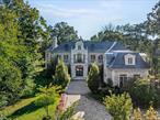 Welcome to 6 Foxwood Road, an extraordinary Colonial estate nestled in the heart of Kings Point, NY. Constructed in 2021, this all-brick and solid stone masterpiece is situated on over one acre of impeccably landscaped grounds, featuring an expansive stone patio, a luxurious in-ground gunite pool, hot tub, and a fully equipped outdoor kitchen - ideal for elegant alfresco dining and effortless entertaining.Showcasing approximately 8, 000 Sq.Ft. of meticulously designed living space, the home offers a dramatic formal layout adorned with soaring ceilings, rich hardwood floors, and impeccable custom finishes throughout. A grand marble foyer with a sweeping bridal staircase sets the tone for refined living, while the formal dining room, complete with a bespoke built-in display case, adds a touch of timeless sophistication.The striking blue high-gloss kitchen is a chefâ€™s dream, equipped with a full suite of top-of-the-line, professional-grade appliances and a polished, mirrored Butlerâ€™s Pantry. A beautifully curved, designated office space offers a stylish and functional workspace, while the oversized family room, featuring chevron-patterned hardwood floors, opens through French doors to the expansive rear patio, which spans the entire length of the home. This seamless indoor-outdoor flow creates a spectacular setting for grand-scale entertaining or tranquil relaxation. Multiple oversized gas fireplaces infuse warmth and character into the living spaces, while Venetian plaster ceilings and thick-cut millwork elevate the homeâ€™s refined aesthetic.The lavish primary wing serves as a private sanctuary, complete with a dedicated vanity area, multiple outfitted walk-in closets, and a spa-inspired en-suite bathroom. A stunning circular glass-enclosed shower serves as the centerpiece, beautifully complemented by a freestanding soaking tub and exquisite marble finishes.This designer residence features 6 spacious bedrooms, 5.5 luxuriously appointed bathrooms, radiant heated floors, a full-house generator, a finished attic space, and a large unfinished basement with tall ceilings, offering endless customization potential. An attached three-car garage completes this exceptional offering - a true statement of luxury living on a waterfront street within the sought-after Great Neck Union Free School District, zoned for North schools.