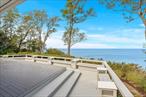 Exceptional Waterfront Retreat â€“ Smart Luxury Meets Modern Comfort. Welcome to this meticulously renovated waterfront home that blends timeless elegance with cutting-edge technology and high-end finishes throughout. Perfectly positioned to capture uninterrupted water views and mesmerizing sunsets, this home offers a front-row seat to natureâ€™s beautyâ€”day after day. Perched high above the water, this stunning residence offers both serenity and sophistication, with every detail thoughtfully curated for modern living. Experience luxury living in this exquisitely renovated waterfront home featuring a gourmet custom kitchen with Thermador & KitchenAid appliances, fully renovated bathrooms with radiant floors, and refinished hardwood floors throughout. Located on over 110 feet of premium waterfront, the property offers panoramic vistas from multiple rooms and outdoor spaces, with expansive TimberTech decks. The outdoor experience is elevated by a hot oil and stone driveway, a motorized awning for BBQ dining, and an Amish-built 12â€™ x 8â€™ shed for stylish and practical storage. New cement board siding with Azek trim, a new roof with custom linear soffit vents, and premium Marvin and Andersen windows/sliders ensure long-lasting style and durability. Inside, the home is flooded with natural light and scenic water views. Bonus features include a conditioned 800+ bottle wine cellar, custom closets, whole-house central vacuum, remote- controlled gas fireplace, and solid-core doors with luxury hardware throughout. Enjoy top-tier systems: Bosch high-efficiency boiler, tankless hot water, full PEX plumbing with manifold, Daikin systems, and Generac transfer switch ready for a whole-house generator. Smart features include custom Lutron lighting & shades, Crestron automation and whole-house audio. Everything has been upgradedâ€”new roof, siding, insulation, and more. Included in the sale is the adjoining .51 acre vacant lot, offering an exceptional opportunity to expand, build, or simply enjoy enhanced privacy and added value. This additional parcel not only increases the overall footprint and investment potential of the property, but also ensures a rare sense of space and seclusionâ€”preserving your personal waterfront retreat from future development and maximizing your enjoyment of the tranquil surroundings.This is more than a homeâ€”itâ€™s a fully automated luxury waterfront sanctuary, where every sunset becomes your private masterpiece. Just move in and enjoy the best of smart living, elevated design, and peaceful waterfront beauty.
