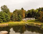 A House by the Pond.A thoughtfully rethought ranch in a private picturesque setting near the end of a dead end road. Delight in the wildlife as sunbeams dance across the pond. Windows act as picture frames for the view. An open and airy layout where all the living space flows. The kitchen anchors with enough space to create epic feasts. Four bedrooms with wonderfully tiled baths. The primary has a screened porch for morning coffee or a nightcap.