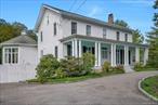 Welcome to this stunning Hudson Valley Greek Revival home, a rare architectural gem that blends historic elegance with modern comfort. Set on a beautifully landscaped, park like property with fruit trees and ornamental gardens, this 4+ bedroom, 2.5 bath home offers a peaceful country lifestyle just minutes from vibrant Hudson Valley villages, towns and amenities. Enter through a circular driveway and be greeted by classic Greek Revival architecture: symmetrical columns, a full length front porch, and tall French style windows that flood the interior with natural light. Inside, a dramatic center hallway with a Federal style staircase and high ceilings sets the tone for this gracious home. The main level includes a sun filled living room with a fireplace, a formal dining room with a crystal chandelier, and a beautifully updated kitchen with granite countertops, center island, and adjacent powder room. A show stopping octagonal great room with soaring ceilings and panoramic windows creates a seamless space for entertaining or relaxing in natureâ€™s embrace.Enjoy indoor outdoor living with multiple porches, perfect for dining al fresco or morning coffee with a view of your private backyard oasis. The second floor features a spacious primary suite with walk in closet and en suite bath, three additional bedrooms, and a newly renovated full bathroom. The third floor includes two bonus rooms, that can be used as an office, bedroom or creative space.The basement adds even more value with a recreation area, laundry room, and wine/root cellar. Additional features include energy-efficient windows, a new 50 year roof with transferable warranty, and plenty of storage space throughout.Located in the heart of the Hudson Valley real estate market, this home is a one of a kind opportunity for buyers seeking historic character, privacy, and spacious living all within driving distance to NYC. or easy access to Metro-North.