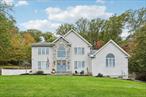 Beautifully maintained colonial with an impressive two-story entry leading to a bright, open layout accented by oversized casement windows throughout. Oak floors run throughout the home, while recessed lighting with adjustable color temperature (warm to 6000K LED) creates a modern, customizable ambiance. The kitchen offers abundant cabinetry and a large eat-in area with a custom island, flowing seamlessly into an airy dining space with sliders to an expansive Trex deckâ€”perfect for entertaining. The family room features a wood-burning fireplace, cathedral ceiling, and opens to a versatile bonus room.Upstairs, the elegant primary suite boasts a tray ceiling, walk-in closet, and a luxurious primary bath with soaking tub, walk-in shower, vaulted ceiling, and skylight. Three additional bedrooms and a full bath complete the upper level. The finished lower level provides flexible living options, including an additional living area, walk-in closet, storage space, and full bathâ€”ideal for guests, recreation, or a home office.This home includes modern upgrades such as in-ceiling speakers in the living room, primary suite, with bath, and garage, perimeter cameras, and a beautifully landscaped exterior with paver walkways. The backyard features a private retreat with a heated saltwater in-ground pool, custom pavers, and landscape lighting. A three-car attached garage and generous driveway provide ample parking.