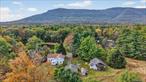 Welcome to 300 Band Camp Road, Saugerties, NY 12477. This is a rare opportunity to own a piece of Catskills history. This 1843 farmhouse with a seasonal cabin and expansive detached garage is tucked along a scenic country drive, surrounded by 4.5 acres of natural beauty with seasonal mountain and pond views. Whether youâ€™re seeking a weekend retreat, full-time residence, or investment opportunity, this property offers the perfect launching pad for your Hudson Valley dreams.The main farmhouse features over 2, 000 square feet of warm, inviting living space with a fireplace, a bright wrap-around three-season porch, and views of sunset over the mountains. Upstairs, youâ€™ll find three bedrooms and a full bath with a charming clawfoot tub, while the main level includes a convenient mudroom, laundry, and half bath with shower. Original details, hidden stairs from the kitchen, and the potential to expose wood beams in the living room add to the homeâ€™s character and possibilities. Upstairs, reimagine the space while maintaining historic details and potentially vaulting many of the ceilings.A separate three-season cabin offers flexible use as a guest house, artist studio, or rental. The farmhouse and cabin have their own septic systems, and the property includes a large detached garage for additional workspace or storage. Recent updates to the farmhouse include a new water heater, heating system, and expansion tank, all located in the basement.While the property offers solid fundamentals and a beautiful structure to build from, itâ€™s ready for your vision. The kitchen and bathrooms await renovation, some plaster walls and flooring need repair or replacement, windows will need to be repaired or replaced, and exterior siding would benefit from paint and maintenance. These improvements will enhance the homeâ€™s charm while preserving its historic soul.Located just eight minutes from the vibrant Village of Saugerties and close to Kingston and Woodstock, this location balances peaceful privacy with easy access to some of the Hudson Valleyâ€™s most beloved towns. Explore the historic village with its indie shops, cafe&rsquo;s, and galleries, or spend weekends hiking the Catskill Mountains, skiing at Hunter or Windham, and discovering nearby cultural landmarks like Opus 40 and the Woodstock Art Colony.300 Band Camp Road is more than a home, itâ€™s an invitation to reimagine a historic Catskills property into your own creative sanctuary.