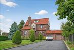 Large Landscaped Brick Tudor with 4-5 bedrooms, 3 full bath and 1 half bath with very large 2 car garage private parking for 10 cars. A must see. Very rare find. Corner property in the heart of Malba.