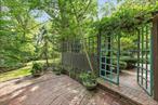 A Peaceful Retreat Among the Trees.  Designed to embrace its natural surroundings, this four-bedroom, two-and-a-half-bath upside-down home offers a bright and inviting second-floor living area with kitchen and open-concept design. Large windows fill the space with beautiful natural light and frame views of the surrounding trees and gardens. The property features multiple private outdoor seating areas, a heated pool, and a deeded beach for easy access to the water. With its peaceful setting and thoughtful landscaping, this home offers the rare feeling of living among the treesâ€”an ideal retreat for nature lovers.