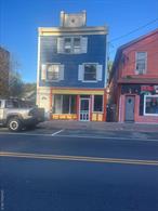 Very convenient location on South Main street next to newly renovated Hijos de Villa restaurant and supermarket, Downstairs was a restaurant with tables and chairs, equipment is still there and usable.Apartment is upstairs, one story walk up. Presently rented.