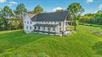 Nestled on a peaceful road with breathtaking views of the Shawangunk Ridge and Mohonk Tower, this stunning modern farmhouse offers 4, 862 square feet of sophisticated living space across five bedrooms and four and a half bathrooms. The heart of this home is the magnificent great room, featuring soaring 36-foot ceilings and a propane fireplace that perfectly frames the spectacular mountain panorama beyond. The chef&rsquo;s kitchen is a culinary dream, showcasing caf&#233;-grade appliances, gleaming quartz countertops, and a generous island that invites both casual meals and elaborate entertaining. The thoughtful open floor plan seamlessly connects living spaces while maintaining distinct areas for relaxation and gathering. The first floor primary suite provides a luxurious retreat with a soaking tub, double vanity, and spacious walk-in closet. Also conveniently located on the main level are the laundry room, home gym, and powder room. Upstairs, a dramatic loft overlooks the great room below, while a full bathroom serves the Jack and Jill bedrooms, each with separate vanity areas. The show-stopping upstairs primary bedroom boasts vaulted cathedral ceilings, panoramic mountain views, a cozy electric fireplace, and an extravagant bathroom featuring beautiful tilework and a soaking tub that gazes into private woods. Additionally upstairs features a spacious home office with its own entrance - perfect for remote work or creative pursuits. This exceptional location provides easy access to outdoor adventures at Minnewaska State Park Preserve, local wineries, and the charming nearby towns of New Paltz and Gardiner. Whether you&rsquo;re hiking, climbing, biking, or exploring farmers&rsquo; markets, endless recreation awaits. Plus, commuting to New York City remains surprisingly convenient, making this the perfect blend of mountain tranquility and urban accessibility.