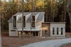 From the creative minds behind Major Jacks and Wishbone, Bear Run is an artful new-construction retreat tucked away on nearly 19 acres of meadow and woodland in the western Catskills, yet just minutes to trending amenities. With intention in every detail, the home balances striking architectural angles, refined design, playful color, and timeless style, with custom-curated finishes throughout. The ground level features a versatile, light-filled studio wing with dramatic windows and skylights, private bedrooms, and a spa-inspired primary suite with soaking tub, walk-in rainfall shower, and radiant-heat floors. Upstairs, an expansive great room with soaring ceilings, white oak floors, and a dual-sided fireplace opens to a blush-toned deck overlooking the landscape. The color-blocked kitchen, centered around a sculptural eat-in island, features tri-tone cabinetry, stainless steel appliances, and a perforated Norwegian fjord-inspired shroud above the oven. Outside, the grounds are a wild counterpoint to the refined interiors. A first-floor atrium, classic fire pit, and a meandering creek invite connection to nature. Bear Run is located in the creative, riverfront town of Narrowsburg, about two hours from NYC. Nearby hiking, kayaking, and swimming along the Delaware River complement a vibrant downtown of vintage shops, galleries, and artisanal dining, with neighboring Callicoon and Barryville offering additional options for exploration, all just 2 hours from NYC.