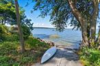 Welcome to Split Rock Cottage, this fully furnished, renovated designer, Centre Island Cape may be the treasure you seek. In an exclusive community with beach and mooring rights, private police, it shares this island with grand estates and high profile individuals. Up the road, Seawanhaka Corinthian Yacht Club provides frequent sailing regattas â€“ fun to watch. A six-minute scenic drive away, Oyster Bay Village offers charming restaurants, shops, waterfront center, and train station. About thirty-five-miles from Manhattan, you can escape the city and be home to your picture-perfect, blue and white cape in about 1.5 hours. This picture-perfect, 3-bedroom, 2-bath, 8-room home will welcome you with a seaside atmosphere, sophisticated appointments, and a beautiful setting for grand, year-round entertaining. Just a short drive from the Locust Valley and Manhasset areas, offers you easy access to premier shopping, dining, theatre, universities, estate museums, and sports venues including golf, boating, equestrian facilities, horse trails, and nature walks. Whether you are searching to upgrade your lifestyle or want a weekend getaway from the city for yourself, or to reward an outstanding employee, or a perk for your favorite customer, this stunning party house is the answer to your dreams. As you turn into your courtyard, you feel right at home. Past lush plantings, charming front door, and front patio with umbrella, table, and chairs, a stone walkway leads between the house and storage shed to an outdoor kitchen and delightful Tiki bar that seats six, with wet bar, television, and water views. Steps descend to a large stone patio, winding lawn, many potted plants, water fountain, luxury seating, hot tub, shady umbrellas, and ample space to accommodate a crowd. Enjoy the firepit with friends or wash off sand and salt in the nearby privacy-fenced shower. A lovely side garden leads up to a deck with dining platform, second gas grill, and another comfortable conversation area. No matter the occasion, whether entertaining a few friends, holding a shindig, taking a hot soak, sunbathing, or enjoying a sunny breakfast, you will love your new home. The homeâ€™s interior boasts a charming foyer with shiplap walls, privacy-glass entry door, closet, and staircase with black iron-and-wire balustrade. Farm-style French doors open to a large study with adjoining bedroom and lovely full bath. Possible first-floor primary suite. The spacious, sunny living room offers water views, a wood-burning fireplace encased in Azui Macaubas polished porcelain and white leathered marble, a huge, framed-picture television, and reclining leather chairs and sofa. The adjoining great room features a vaulted ceiling and a stunning lapis-lazuli accent wall and skylights in the â€œbubble loungeâ€ area. An L-shaped marble breakfast bar, with seating for seven, flows into the kitchen offering ample white oak cabinetry, stainless steel appliances, sliders to the dining deck, and a door into the one-car garage with lift, now used as a deluxe gym with door to deck. The second floor features a lavish Azui Macaubas polished porcelain and white leathered marble primary bath, an immense four-season, walk-in closet with water views, and a luscious primary bedroom- authentic alligator bed. The lower level provides room for fun with billiard table, coffee bar/beverage station-mini refrigerator, Sorrento game table (poker, roulette, chess, checkers, backgammon), and a striking designer bath. Additional features include two-zone climate control for central air and electric forced air; portable backup generator (propane or diesel); access panel in study; new roof in 2024; gutter guards; and cesspool serviced 2024. Just 800-avenue-feet is the local private beach where you can swim, paddleboard, kayak, and moor your boat. Come, sail across the harbor to Coopers Bluff or enjoy the famous lobster salad at The Clam Bar at Bridge Marina. Turn-key, Low Taxes! View 3D tour & floor plan.