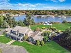 This Stunning Waterfront Estate Offers An Unparalleled Blend Of Luxury And Nature On Nearly 2 Acres Along Champlin Creek. The Home Features Charming Cedar Shake Roofing And A Grand Two-Story Entry. Inside, You&rsquo;ll Find Wide Plank Wood Floors And Custom Finishes That Enhance The Open Floor Plan, Which Includes A Barn-Style Family Room/Bar With A Cozy River Stone Fireplace. The Custom Kitchen Is Equipped With Stainless Steel Appliances, Perfect For Culinary Enthusiasts. Outdoors, The Property Is An Entertainer&rsquo;s Dream, Boasting An Expansive Cedar Deck, An In-Ground Pool With A Hot Tub And Swim Spa, Pergolas For Shade, A BBQ Station For Al Fresco Dining, A Halfpipe And More. Additional Highlights Include A Boat Cut-In With A Lift And A Spacious 7-Car Detached Garage. This Estate Truly Combines Elegance With A Serene Waterfront Lifestyle. ****This Sale Does NOT Include The Additional 2.35 Acre Lot****