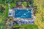 Itâ€™s never too early to think about spending lazy summer days poolside! The exterior is in the process of being repaired and painted just in time for the holiday season! Top of the Ridge is a sought-after townhome community in the distinguished Rye Neck School district. The recently renovated open-concept kitchen & dining area (2020) seamlessly flow to a private, expanded brick paver patio providing the perfect extension to this home. Enjoy a summertime favorite - BBQ & outdoor eating & entertaining! The luxurious kitchen features elegant brass finishes, stunning quartzite countertop, beverage refrigerator, & island with bar stool seating. Abundant cabinet and counter space will appeal to the chef & convenient laundry room makes everyday living a breeze. Just a few steps up, the spacious living room features a volume ceiling, expansive windows flooding the space with natural light, fireplace, & sliding glass doors leading to a private deck. A conveniently located powder room completes this level. Ascend to the tranquil privacy of the next level. The primary bedroom is an inviting retreat bathed in natural light from oversized windows. The recently renovated bathroom shines with elegant marble floors & tilework, featuring a dual-sink vanity for effortless morning routines & the customized walk-in closet completes the ensemble creating a beautifully tailored haven. Second bedroom & updated bath complete this level. The new vanity features a pull-out bottom step so little ones can reach the sink. The top level unveils an inspiring bonus room. Bathed in natural light from a skylight it offers a world of possibilities. Serene home office, a stylish guest room, or a dedicated yoga & exercise studio, this space adapts to your lifestyle needs. Enjoy lazy summer days at the community pool. This home is designed to elevate your lifestyle both indoors & out and is convenient to shopping, transportation and the Metro North train station to NYC.