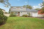 Located in the highly desired Smithtown school district, this well-built builderâ€™s colonial offers modern updates and timeless charm. The spacious floor plan features a large primary bedroom plus three additional bedrooms and a full bath upstairs. The main level includes a welcoming living room, formal dining room, and a stunning eat-in kitchen with quartz countertops and stainless steel appliances. A cozy den with a brick fireplace, a convenient mudroom with access to the deck and one-car garage, and a half bath complete the first floor. The home also includes a full unfinished basement, new windows, roof, bathrooms, and hardwood floors throughout. Outside, enjoy a level yard with a three-zone in-ground sprinkler systemâ€”perfect for entertaining or relaxing.