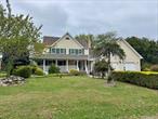 This exquisite farmhouse has deeded beach rights and is just a short stroll from the Long Island Sound located slightly west of Iron Pier Beach. Grab beach chair and go down the private road to the beach. This sprawling custom home features the curb appeal you have been looking for with a large wrap around porch. Enter into the foyer introducing the character of the home, the formal living room and dining room have hardwood floors, oversized windows and plenty of natural light. The custom kitchen boasts an oversized refrigerator, cooktop, double oven, dishwasher, trash compactor and food disposal, pantry, island and peninsula with granite countertops. The kitchen opens into the den with a wall of windows, cathedral ceiling, French doors to deck, wood burning fireplace and loft above. Just off the den is an office with outside entrance, built in cabinets and desk. Upstairs, you&rsquo;ll find the primary bedroom with beautiful windows and ensuite bathroom with radiant heated floors, plus three other spacious bedrooms and a full bathroom. As a bonus, a cozy loft overlooks the den and also provides access to large storage area over the garage. The stairs to a large unfinished attic provides more storage than you would ever need. The full basement is filled with possibilities and has sliding glass doors opening to the patio and plenty of natural light. The radiant heated floors in the three car garage makes for a comfortable work area. Choose whether to entertain your guests on the patio, up on the deck or along side the inground pool. Come take a look at this one of a kind farmhouse by the Sound!
