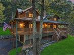 Remarkable Private Retreat: 8 Acres with Custom 3-Story Log Cabin in Warwick.  Experience the best of Hudson Valley living in this extraordinary, privacy-forward property. Set on 8 wooded acres, this custom-built log cabin designed by Fred Krol of Log Chip Homes blends rustic charm with modern convenience, delivering a lifestyle that discerning buyers seek and investors value. The property features a 3-story, custom log cabin on 8 private acres with an open-concept living room that showcases a stone hearth, wood stove, soaring ceilings, wide plank wood floors, and exposed wood beams. The chef-inspired kitchen is equipped with new stainless appliances, corian countertops, and a tumbled slate backsplash, with an exterior doorway to the rear yard that facilitates seamless indoor-outdoor living. On the first floor, the primary suite offers a large walk-in closet and a spa-inspired bath with a Jacuzzi tub and dual sinks, plus access to an 800 square-foot wraparound porch. For comfort and safety, the home includes a brand-new alarm system, central air conditioning, a furnace system, and a whole-house water purifier. Outdoor living and storage are well-catered for, with a heated two-car garage, a large storage shed, and a partially finished basement that provides versatile potential. Upstairs, there is ample closet space, a loft, and a full bath. A standout family-friendly feature is the kidsâ€™ tree house tucked among mature trees, offering a playful retreat and a unique backyard amenity. This property has been enjoyed as both a private escape and an income-producing retreat. A detailed short-term rental income report is available upon request, offering a clear view of how this home can generate revenue while preserving privacy and serenity. Warwick, hailed as the apple capital of the Hudson Valley, is renowned for its natural beauty and tight-knit community. Highlights include Applefest and year-round orchards, farm-to-table dining, artisanal shops, wineries, and breweries. Greenwood Lake seasonal pass access provides lakefront recreation such as swimming, fishing and there are plenty of marinas for boating and other water sports, and Mt. Peter Ski Area offers winter fun. This area consistently attracts buyers seeking a balanced lifestyle of leisure, outdoor adventure, and investment growth. The propertyâ€™s combination of seclusion, and close proximity to the Village of Warwickâ€™s amenities makes it a standout opportunity. Donâ€™t miss your chance to own a distinctive, value-forward property that encapsulates the essence of outdoor living in Warwick. Schedule your private tour and explore the full potential of this exceptional home.