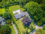 Exquisite, Better-Than-New Estate Ranch. Meticulously rebuilt from the ground up, this sprawling ranch sits at the serene end of a private cul-de-sac, offering the ultimate blend of sophistication, privacy and year round resort living. Step outside to professionally landscaped grounds highlighted by a heated in ground pool, extensive stone patios and multiple lounging and entertaining areas-all creating a true country-club oasis. Inside, a state-of-the-art gourmet kitchen showcases top tier appliances, custom cabinetry and gas cooking. The sun drenched family room with soaring cathedral ceilings frames dramatic views of the spectacular backyard retreat. Additional distinctions include seperate guest quarters for VIP visitors, impeccable Like New condition throughout. Also available for sale.