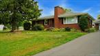 Timeless brick ranch, ideally situated in the heart of Hudson on two adjoining 0.20 acre lots. A rare find just minutes from Amtrak and a short walk to vibrant Warren Street. The second lot offers a unique opportunity: build a guest home, studio, or investment property, or simply enjoy the luxury of 0.40 acres of in-town space. Inside, gleaming hardwood floors, and a wood-burning fireplace create an inviting, classic atmosphere. The semi-open layout flows easily from the light-filled living room to the dining area, right to the outdoors. A finished lower level with gas fireplace and built-in bar provides an ideal setting for entertaining or relaxing. The vintage tile bath adds a touch of retro charm with room for your personal updates. Recent improvements include a new natural gas furnace with indirect water heater (2024), repaved driveway (2023), new chimney cap (2025). A detached single-car garage completes the offering. Blending classic character with thoughtful updates and a prime location, this property presents both comfort and opportunity â€” a true Hudson gem ready for its next chapter.