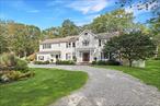 Perfectly sited at the end of a quiet cul-de-sac, this Pound Ridge residence combines timeless charm with modern comfort on two beautifully landscaped acres. Surrounded by specimen plantings, gardens, and mature trees, the property offers exceptional privacy, a large level yard, a stone-lined koi pond, and a stunning slate patio with a fire pit - an ideal setting for entertaining or simply enjoying the outdoors. Inside, the home is rich with detail, featuring wide-board floors, custom moldings, and built-ins throughout. The heart of the home is the gorgeous kitchen, designed with marble countertops, a beadboard ceiling, brass pendant lighting, and a large center island that invites gathering. A commercial-grade range, separate full-size Sub-Zero refrigerator and freezer, and farmhouse sink make the space both beautiful and functional. The kitchen opens seamlessly to the family room, where exposed beams and a stone fireplace create a warm and inviting atmosphere. Additional features include new composite siding, a new roof, many new windows, central air, and a whole-house generator. The finished lower level (not included in the listed square footage) adds flexible living space, while the circular drive enhances curb appeal. With a potential pool site and peaceful setting just minutes from town, this property offers the best of country living-only about an hour from New York City.