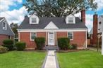 Location, Location, Location!!! Discover this expanded brick Cape situated in the vibrant heart of Carle Place. Step into the inviting living room, featuring a cozy wood-burning fireplace, and seamlessly transition into the eat-in kitchen, which offers convenient access to the rear patio nestled within a private, fenced backyard. This charming home boasts two bedrooms and a full bathroom on each floor, culminating in a total of four bedrooms and two full baths. Enjoy the additional space provided by the partially finished basement and the practicality of a detached garage. The home is equipped with oil heating and gas cooking, and showcases elegant hardwood floors throughout. New brick lined front walkway and roof with 25 year warranty. Ideally located, this property is in close proximity to the LIRR, public transportation, schools, shopping, and all essential amenities.