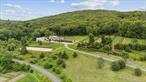 An equestrian paradise on 20 acres just minutes from Metro North and charming Cold Spring village. Every aspect of this property reflects the sellerâ€™s meticulous vision - from the materials and craftsmanship to the thoughtful layout designed with ease and purpose in mind. With a state-of-the-art 16-stall banked metal barn with separate office/day room, indoor and outdoor arenas, 7 outdoor paddocks and an acre of fenced land ready for gardening, this property is a true gem for horse lovers and outdoor enthusiasts alike. The live-in space is a beautiful 2 bedroom 2 bath bathed in southern sunlight and complete with luxury finishes, perfect for you or a caretaker to call home. Framed by mountain ridgelines and sunset skies and with 20 acres to shape as you wish, youâ€™ll have room to build additional structures, extend your equestrian footprint, or simply enjoy the peace of open landâ€”all just a short train ride from Manhattan.