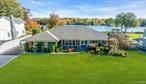 Located on Knapps Lake, this truly custom wide line brick ranch offers the perfect blend of comfort & privacy with picturesque and serene views from almost every room. The heart of the home is the eat-in kitchen, complete with granite countertops, double oven, dual sinks, island and ample space for gathering. Open flow to the cozy retreat in the den with wood burning fireplace and a beautiful sunroom with a wall of windows and dual access to the patio. The formal living room with floor to ceiling windows provides beautiful natural light with a clear view of the neighborhood, while the large dining room with oversized windows extends your views to the lake, park and a beautifully crafted paver patioâ€”ideal for outdoor dining and enjoying your piece of paradise. Specimen trees and mature landscaping are beautiful in every season yet there is room for a pool and space to personalize the yard for your preferences.  Hardwood and tile flooring flow throughout, complemented by radiant heatâ€”no baseboards in sight. The home is a must see to appreciate â€“ there are so many features and upgrades setting this home beyond your expectations, including 2 zone central air, natural gas including to BBQ, in ground sprinklers, crown moldings, architectural roof with 3&rsquo; overhangs. Need storage? We have plenty of that as well with a walk up attic and a two car garage like no other with Modine heater & custom built ins. This is the home that invites you to experience every season with a true Courier and Ives setting.
