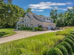 Built in 2005 and gracefully sited on 1.18 acres overlooking North Sea Harbor&rsquo;s peaceful Fish Cove, this 5, 100&#177; sq. ft. residence captures the essence of Hamptons waterfront living. Expansive glass windows and French doors fill the interiors with natural light and frame serene harbor views from nearly every room. The main level offers a gracious entry foyer, a generous kitchen with premium appliances, and open dining and living areas designed for gatherings that flow seamlessly outdoors. A sunroom, a living room with a fireplace, and a family room with a fireplace create inviting spaces to relax, while an en-suite guest room and three-car garage complete the first floor. Upstairs, two oversized and sunny primary suites each open to private sundecks, accompanied by two additional ensuite bedrooms. Outside, a spacious mahogany deck leads down to a bluestone patio that surrounds a 40&rsquo;x20&rsquo; heated gunite pool, nestled among expansive lawns and mature landscaping-perfect for entertaining or enjoying peaceful mornings by the pool and water. Adding tremendous versatility is a 2, 400&#177; sq. ft. unfinished lower level with 11-foot ceilings, offering abundant space for future recreation, media, or fitness rooms. Included with the property is a separate 1.3-acre waterfront parcel with a private dock, providing direct access to boating on Peconic Bay, and making this a total of 2.48 waterfront acres. With panoramic harbor and cove views, indoor-outdoor living, and rare dual parcels, this 2005-built North Sea Harbor retreat embodies the best of the Hamptons lifestyle-minutes from Southampton Village and ocean beaches.