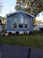 Welcome to Hometown America Glenwood Village!A Stunning immaculate 2-bedroom, ranch-style manufactured home, built in 2008, has just hit the market and is ready for its new owner. Step inside and be greeted by a spotless, bright, and airy interior. The eat-in kitchen features crisp white cabinetry, updated appliances, and sunshine-bringing skylights.The home offers a highly desired split bedroom layout floor plan for maximum privacy. The primary suite is a true retreat, boasting a large bedroom and an en-suite master bath complete with a spacious walk-in shower. At the opposite end of the home, you&rsquo;ll find the second full bathroom and an additional guest bedroom. Outdoor living & convenience Enjoy quiet, private gatherings on your Trex deck, thoughtfully bordered by privacy trees. The property also includes a convenient carport and a shed for all your extra storage needs.Don&rsquo;t miss this opportunity! This is hands-down the best buy on Long Island for senior living. Call today.