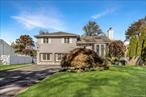Welcome to this 4-bedroom, 2-bath split-level high ranch set on a quarter-acre lot in Smithtown. With vaulted ceilings, skylights, and south-facing exposure, natural light fills the home from morning to evening. The entry opens to a large living room with bay window, connecting seamlessly to a spacious dining area and updated eat-in kitchen that features recessed lighting and sliding doors to a raised deck - perfect for indoor-outdoor entertaining! Upstairs offers three well-sized bedrooms with exposed hardwood floors and a Jack-and-Jill full bath shared by the primary bedroom and hallway. The lower level includes ground-level backyard access, a second living space or den, plus an additional bedroom and bath. The finished basement adds even more versatility with a recreation area and separate utility/storage room. The expansive backyard and multi-car driveway complete this bright, inviting home thatâ€™s been thoughtfully updated and ready for your finishing touches.