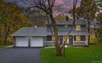 Discover comfort, style, and space in this exceptional 3-bedroom, 3-bath colonial nestled on over an acre of private, wooded land. The centerpiece of the home is the spectacular chefâ€™s kitchen, featuring vaulted ceilings, quartz countertops, a built-in microwave, an oversized Viking range, and high-end appliances. Three skylights with remote-controlled blinds fill the room with natural light, while the large peninsula offers plenty of seating, and a cozy breakfast nook opens through French doors to one of two spacious decks overlooking the peaceful backyard.Host gatherings in the elegant dining and living room combo, or unwind in the inviting family room with its striking stone fireplace. A covered front porch welcomes you home, and the attached two-car garage provides easy access. The full walk-out basement offers endless possibilities for expansion, storage, or a future recreation space.Located just 5 minutes from Route 84, this home offers the best of both worlds with quiet surroundings and close proximity to shopping, dining, and major commuter routes. A rare find that combines modern luxury with timeless charm.