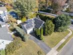Welcome to this traditional split located in the heart of Amityville Village. This beautifully maintained home features gleaming hardwood floors, sun filled rooms, and charming bay windows that bring in natural light. Enjoy peace of mind with a newer roof installed in 2018, energy efficient solar panels, and central air for year round comfort. Sliding doors from the dining room lead to a private rear deck surrounded by mature trees, creating the perfect space to relax or entertain. Thoughtful updates throughout add to the appeal of this inviting home. Conveniently located near village shops, restaurants, parks, and the LIRR, this home offers the ideal blend of comfort, charm, and location.