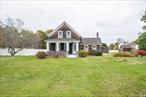 Step back in time while enjoying the warmth and character of this beautifully preserved farmhouse set on a picturesque .67-acre property in the heart of Bohemia. Featuring classic cedar siding, a cedar shake roof, and a welcoming front porch, this home exudes timeless country appeal. Inside, youâ€™ll find two cozy bedrooms and one full bath, along with a formal dining room, inviting living room, and a sunlit eat-in kitchen. Just off the kitchen, a spacious pantry and convenient laundry room add modern practicality to this charming historic home. Original details such as wainscoting, moldings, and millwork have been lovingly maintained, preserving the homeâ€™s authentic farmhouse character. Outdoors, the property is a collectorâ€™s dream with an oversized barn (1310 sq ft) with loft that can house up to five antique cars, a 96 sq ft corn crib and an original outhouse, offering a rare glimpse into the areaâ€™s rural heritage. Updated electric (100 amp) in 2020, gas furnace replaced in 2023, cedar roof replaced on barn in 2019.